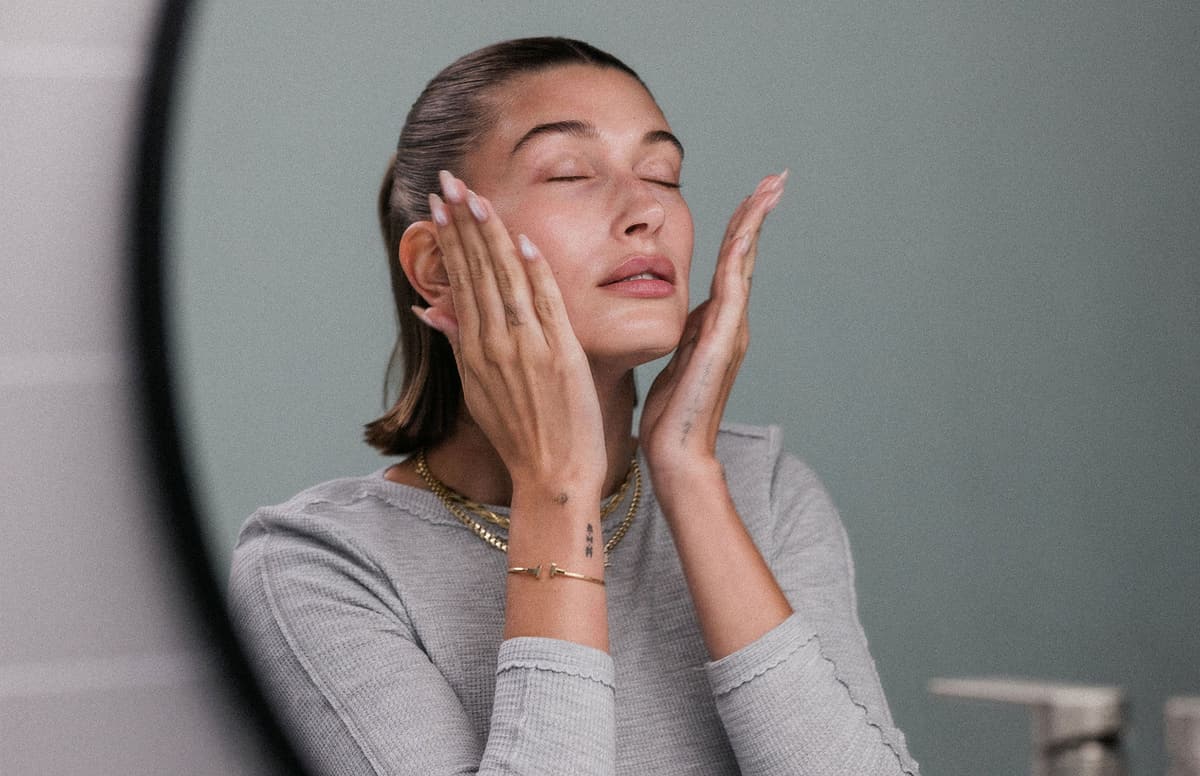 Hailey Bieber applying Glazing Milk on face