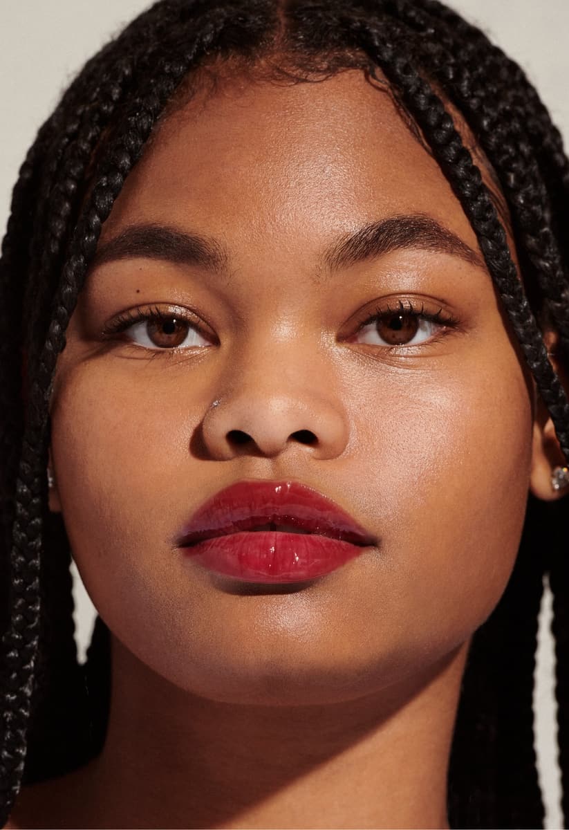 model with glossy lips, wearing raspberry jelly lip tint