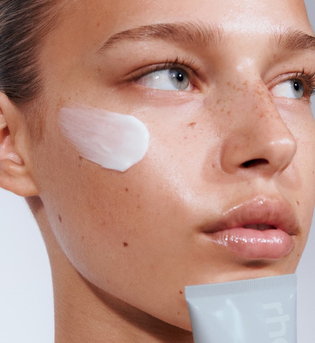 model with a swatch of barrier restore cream on her face