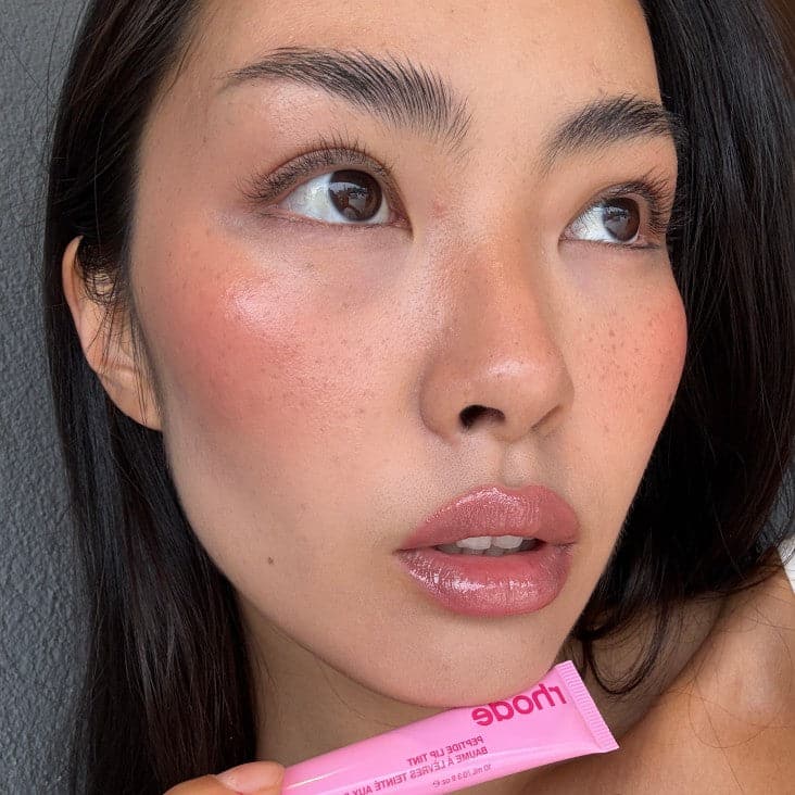 model wearing peptidel ip tint in jelly bean