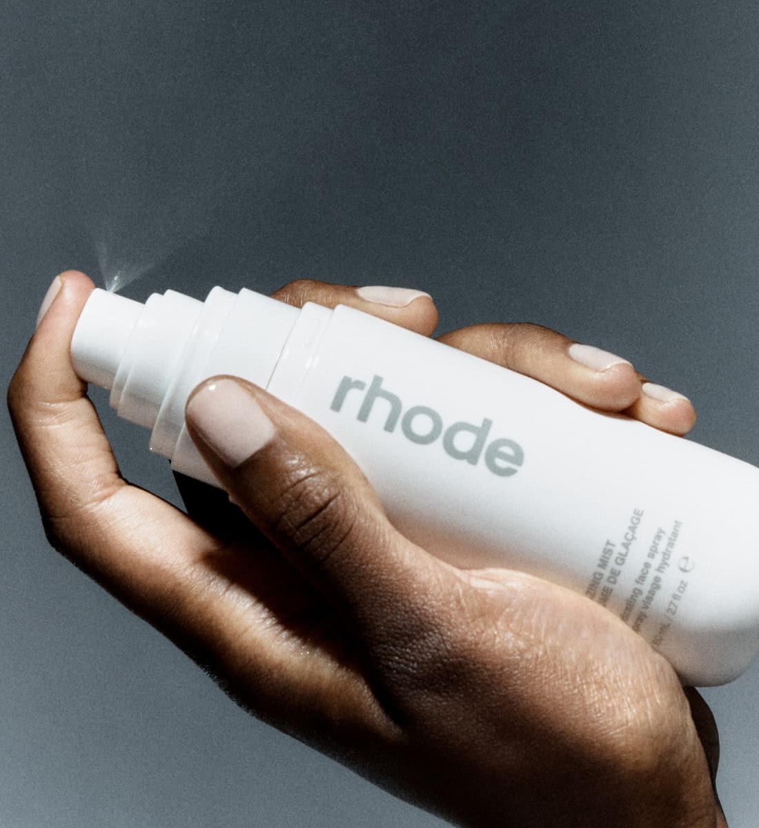model's hand holding glazing mist